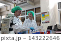 Laboratory room. Female scientists conducting laboratory research with colorful chemical samples. Using test tubes flasks and microscopes for scientific analysis and experimentation. Bio or chemical. 143222646