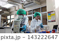 Laboratory room. Female scientists conducting laboratory research with colorful chemical samples. Using test tubes flasks and microscopes for scientific analysis and experimentation. Bio or chemical. 143222647