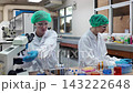 Laboratory room. Female scientists conducting laboratory research with colorful chemical samples. Using test tubes flasks and microscopes for scientific analysis and experimentation. Bio or chemical. 143222648