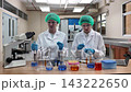 Laboratory room. Female scientists conducting laboratory research with colorful chemical samples. Using test tubes flasks and microscopes for scientific analysis and experimentation. Bio or chemical. 143222650