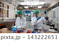 Laboratory room. Female scientists conducting laboratory research with colorful chemical samples. Using test tubes flasks and microscopes for scientific analysis and experimentation. Bio or chemical. 143222651