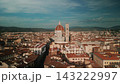 Forward drone shot approaches Florence Cathedral, emphasizing Brunelleschi Dome, Giotto Campanile and surrounding Renaissance rooftops. 143222997