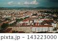 Smooth sideways drone flight surveys red roof neighborhoods, urban avenues and rolling hills surrounding Florence. 143223000