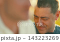 People talking and smiling in a park during a sunny afternoon in a lively outdoor setting 143223269