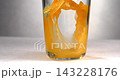 Fresh orange juice pouring into clear glass in slow motion 1000 fps 143228176