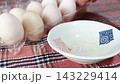 Premium eggs from Silkie chickens. Presented in a clear plastic carton and served on a white plate. 143229414