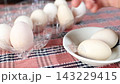 Premium eggs from Silkie chickens. Presented in a clear plastic carton and served on a white plate. 143229415