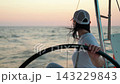 Yacht sailing on sea, woman captain controls marine vessel. Woman helm of yacht. Captain woman helm of ship sailing on ocean. Sea voyage. Captain helm of schooner. Make dream Sail towards adventure 143229843