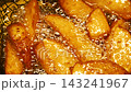 Close-up slow motion fried crispy potato wedges deep frying in oil. French fries 143241967
