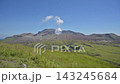 The landscape of Aso with white volcanic smoke rising from a grassy field of pampas grass in early autumn. 143245684