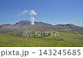The landscape of Aso with white volcanic smoke rising from a grassy field of pampas grass in early autumn. 143245685