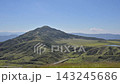 The landscape of Aso with white volcanic smoke rising from a grassy field of pampas grass in early autumn. 143245686