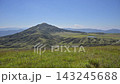 The landscape of Aso with white volcanic smoke rising from a grassy field of pampas grass in early autumn. 143245688