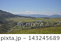 The landscape of Aso with white volcanic smoke rising from a grassy field of pampas grass in early autumn. 143245689