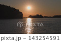 Breathtaking sunset over calm ocean waters with golden light reflections on the gentle ripples near dark shore. Seaside landscape near the city of Vlore in Albania, Europe. 143254591