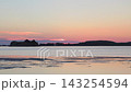Serene Sunset Over Calm Ocean Water With Distant Island Silhouettes And Soft Pink Sky Colors During Peaceful Dusk. Seaside landscape near the city of Vlore in Albania, Europe. 143254594