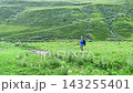 Male hiker approaching car in wide view after a mountain trek in Svaneti, Georgia, travel scene for trailhead transport, self-drive tourism, hiking logistics, and outdoor trip planning services 143255401