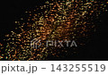 Glowing golden particles stream across a dark background 143255519