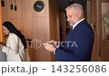 Business professionals connect in a modern office space during a bustling event 143256086