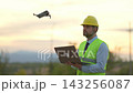 Asian woman uses technology to explore the world during golden hour 143256087