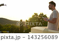 Capturing the sunset magic while flying a drone in a serene landscape 143256089
