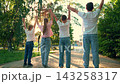 Boy, girl raise their hands. Teamwork children, group children playing in city park. Successful team winning children. Teamwork in family. Friends together in outdoors. Children success victory. Sport 143258317