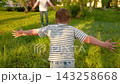 Happy child son hugs dad in summer park. Loving father hugs little boy. Family holiday. Father Day. Carefree childhood in father arms. Family, mom child. Kid happily playing outdoors with parents 143258668