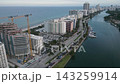 Aerial glide past a waterfront construction crane and miami beach towers 143259914