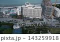 Aerial sweep past miami beach high rises and a marina lined waterway 143259918
