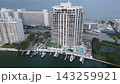 Aerial drift above a miami beach waterfront complex with tennis courts and yachts 143259921
