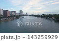 Aerial cruise along a calm miami beach intracoastal channel lined with towers and yachts 143259929