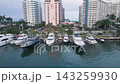 Aerial sweep past a miami beach marina and pastel waterfront towers 143259930