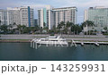 Aerial pass along a miami beach canal past docked yachts and pastel towers 143259931