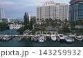 Aerial glide over a miami beach waterway lined with towers and moored yachts 143259932