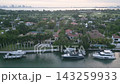 Aerial flyover of lavish waterfront estates lining a miami beach canal 143259933