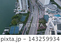 Aerial glide above Collins Avenue past waterfront towers and marina docks 143259934