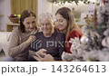 Happy family taking selfie with smartphone during christmas time 143264613