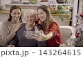 Happy family taking selfie with smartphone during christmas time 143264615