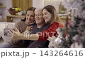 Happy family taking selfie with smartphone during christmas time 143264616