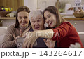 Happy family taking selfie with smartphone during christmas time 143264617