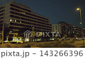 Nighttime urban street view with modern buildings and streetlights 143266396