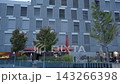 Modern building facade with outdoor seating and trees in Madrid 143266398