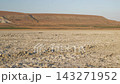 The camera moves over the bed of a dry lake. 143271952