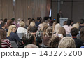 Audience facing a speaker in a dark jacket 143275200