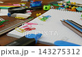 Scattered school and office supplies create dynamic workspace 143275312