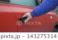 Driver tries to unlock the door of the frozen car in glaze ice but fails 143275314