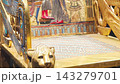 Gilded royal throne of ancient Egypt featuring intricate lion-head carvings and turquoise inlay. 143279701