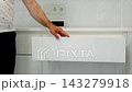 Male hand opening and closing upper drawer of modern white handleless cabinet in clean dental clinic creating organized medical workspace close up video 143279918