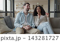 Young Couple Talking On Sofa While Woman Sharing Story At Home 143281727