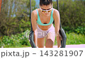 Sunlit park scene showing gymnast building core strength and stability 143281907